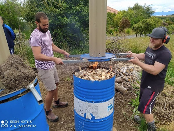Fig. 3: A.J., a civil contractor and jack-of-all-trades, produced four drums with chimneys for burning wood and biomass to make biochar; see Video 1 (Image: Nelson Whakatu Microforest)